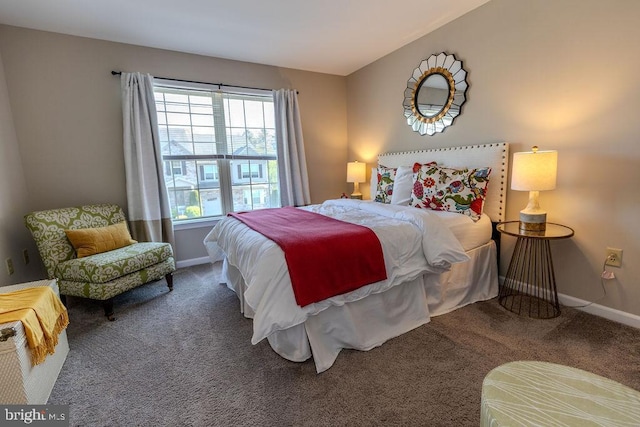 carpeted bedroom featuring baseboards