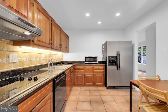 9235 E Parkhill Dr, Bethesda, MD 20814 - kitchen with black appliances, under cabinet range hood, a sink, brown cabinetry, and backsplash