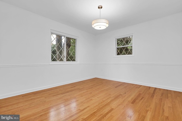 9235 E Parkhill Dr, Bethesda, MD 20814 - unfurnished room with healthy amount of natural light, light wood-style flooring, and baseboards