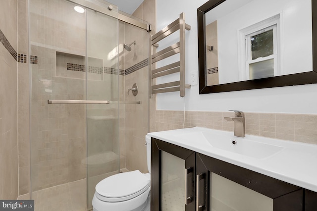 9235 E Parkhill Dr, Bethesda, MD 20814 - bathroom with radiator, a stall shower, vanity, toilet, and tile walls