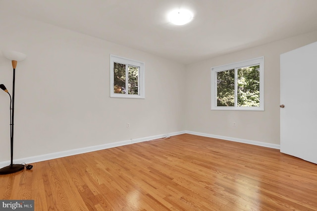 9235 E Parkhill Dr, Bethesda, MD 20814 - empty room with plenty of natural light, light wood-style flooring, and baseboards