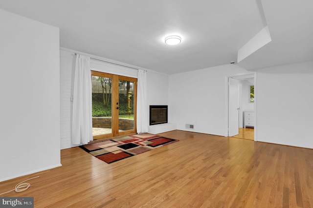 9235 E Parkhill Dr, Bethesda, MD 20814 - unfurnished living room featuring wood finished floors and a fireplace