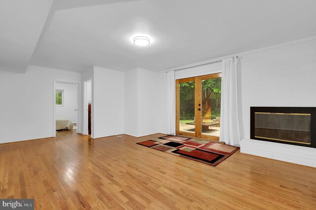 9235 E Parkhill Dr, Bethesda, MD 20814 - unfurnished living room featuring wood finished floors and a brick fireplace
