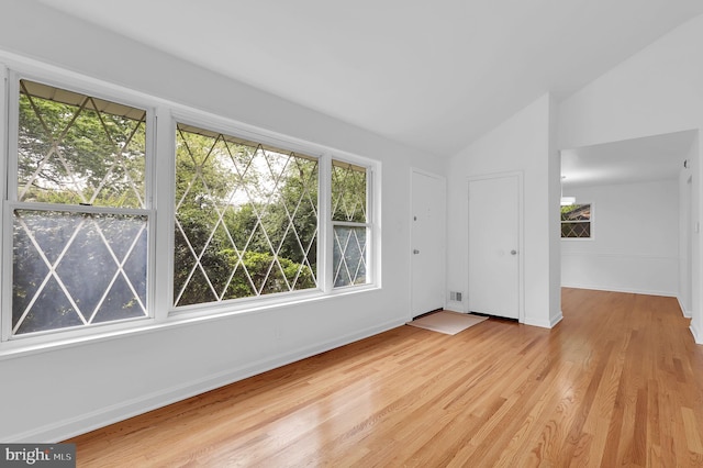 9235 E Parkhill Dr, Bethesda, MD 20814 - empty room with vaulted ceiling, light wood-style floors, and baseboards