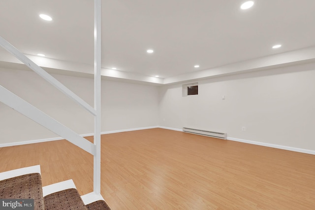 9235 E Parkhill Dr, Bethesda, MD 20814 - finished basement featuring a baseboard radiator, wood finished floors, recessed lighting, and baseboards