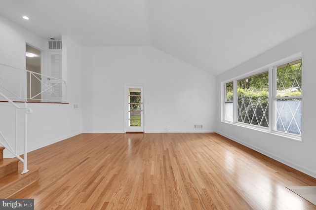 9235 E Parkhill Dr, Bethesda, MD 20814 - unfurnished living room with lofted ceiling, light wood-style flooring, stairway, and baseboards