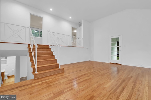9235 E Parkhill Dr, Bethesda, MD 20814 - unfurnished living room with wood finished floors, stairs, recessed lighting, and baseboards