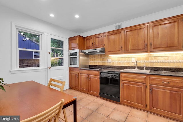 9235 E Parkhill Dr, Bethesda, MD 20814 - kitchen with black appliances, a sink, dark countertops, under cabinet range hood, and decorative backsplash