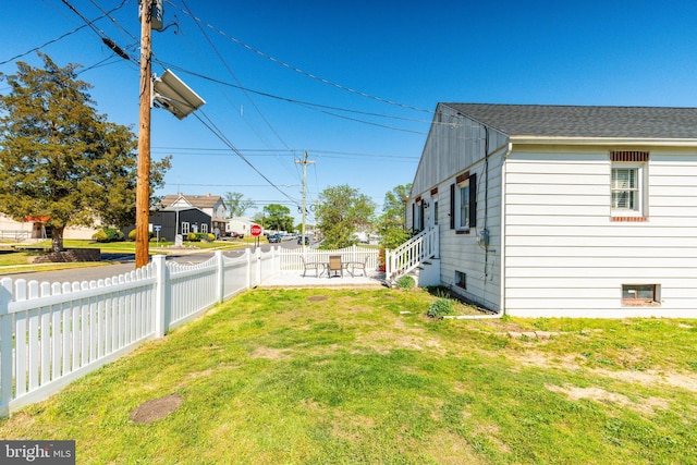 view of yard featuring a patio and fence