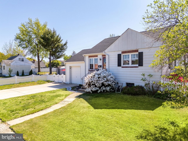 view of front of property featuring a garage, fence, a front yard, board and batten siding, and concrete driveway