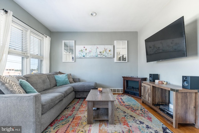 living room featuring wood finished floors and visible vents