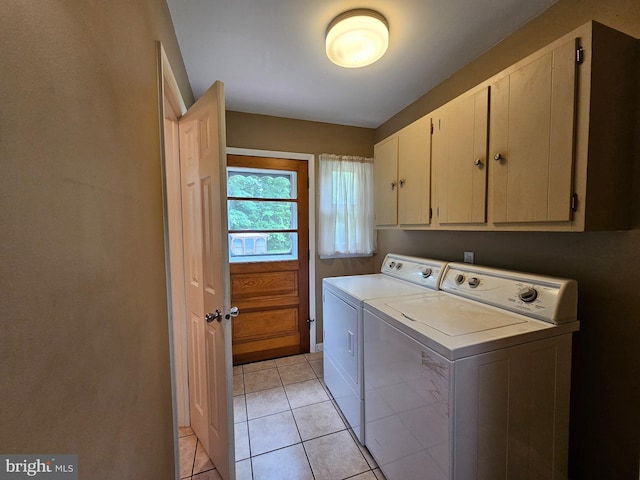 clothes washing area with independent washer and dryer, cabinet space, and light tile patterned floors