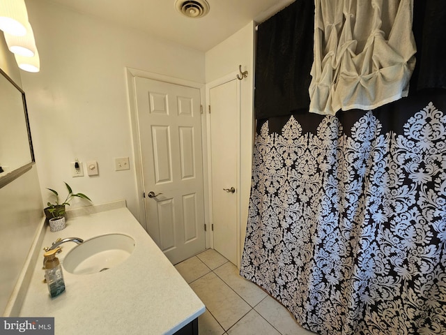 bathroom with vanity and tile patterned flooring