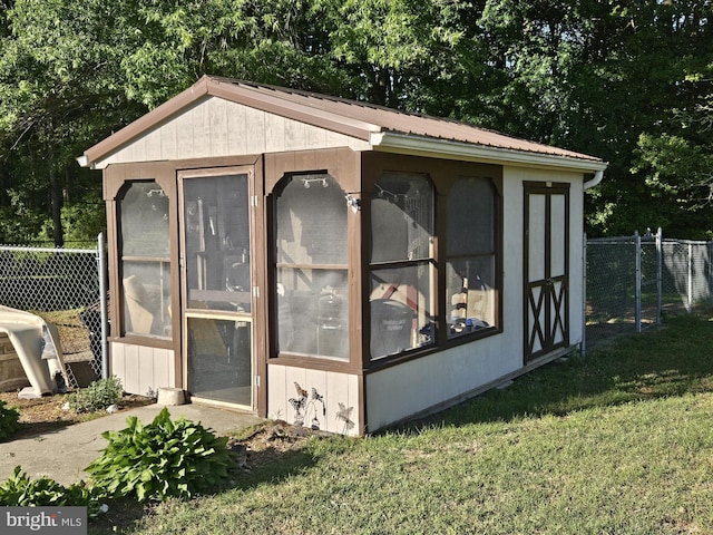 view of outdoor structure featuring an outbuilding and view of scattered trees