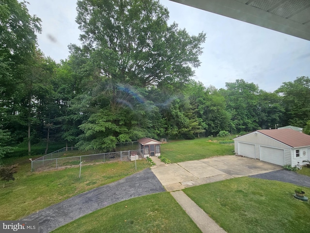 view of yard featuring an outbuilding and a garage
