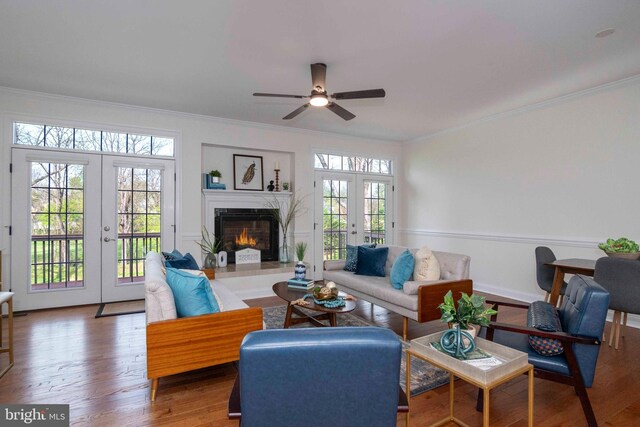 living area featuring french doors, ceiling fan, and ornamental molding
