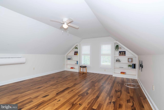 bonus room featuring wood finished floors, ceiling fan, built in shelves, baseboards, and lofted ceiling