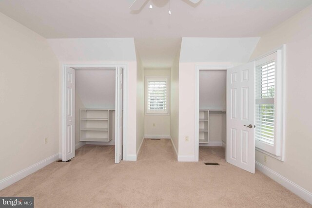 unfurnished bedroom featuring visible vents, light carpet, and baseboards