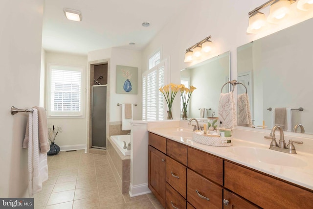 full bath featuring tile patterned floors, a shower stall, double vanity, and a sink