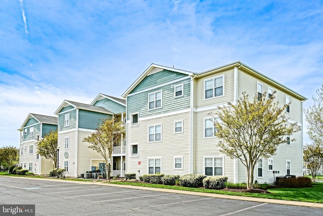 33192 N Village Loop Unit 5204, Lewes, DE 19958 - view of building exterior featuring cooling unit and uncovered parking
