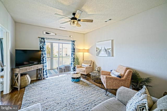 33192 N Village Loop Unit 5204, Lewes, DE 19958 - living area with visible vents, wood finished floors, a ceiling fan, and a textured ceiling