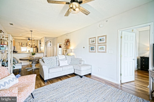 33192 N Village Loop Unit 5204, Lewes, DE 19958 - living area featuring baseboards, visible vents, wood finished floors, and ceiling fan with notable chandelier