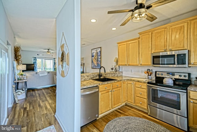 33192 N Village Loop Unit 5204, Lewes, DE 19958 - kitchen with decorative backsplash, a sink, appliances with stainless steel finishes, dark wood finished floors, and a ceiling fan