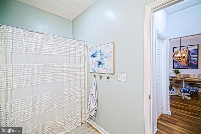 33192 N Village Loop Unit 5204, Lewes, DE 19958 - full bathroom featuring a textured ceiling, wood finished floors, and a shower with curtain