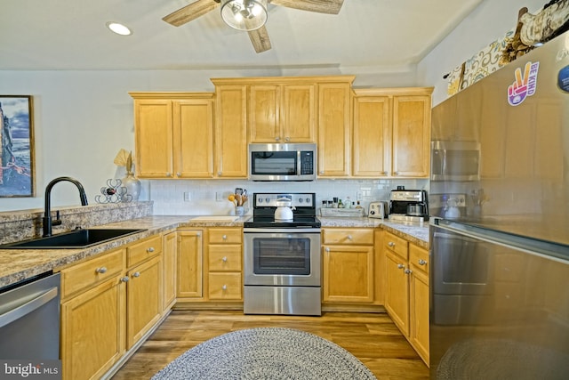 33192 N Village Loop Unit 5204, Lewes, DE 19958 - kitchen featuring stainless steel appliances, light wood finished floors, light countertops, and a sink