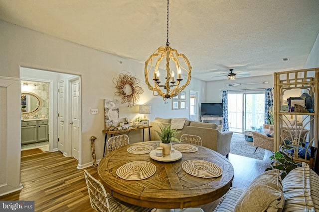 33192 N Village Loop Unit 5204, Lewes, DE 19958 - dining room featuring a textured ceiling, wood finished floors, and ceiling fan with notable chandelier