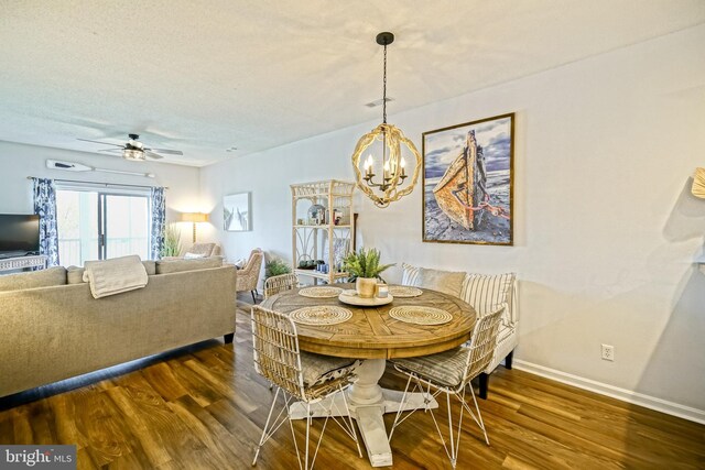 33192 N Village Loop Unit 5204, Lewes, DE 19958 - dining area featuring baseboards, wood finished floors, and ceiling fan with notable chandelier