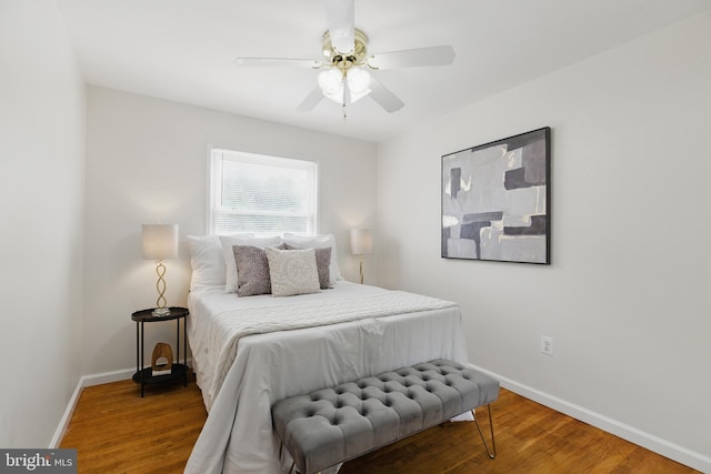 bedroom with baseboards, wood finished floors, and ceiling fan