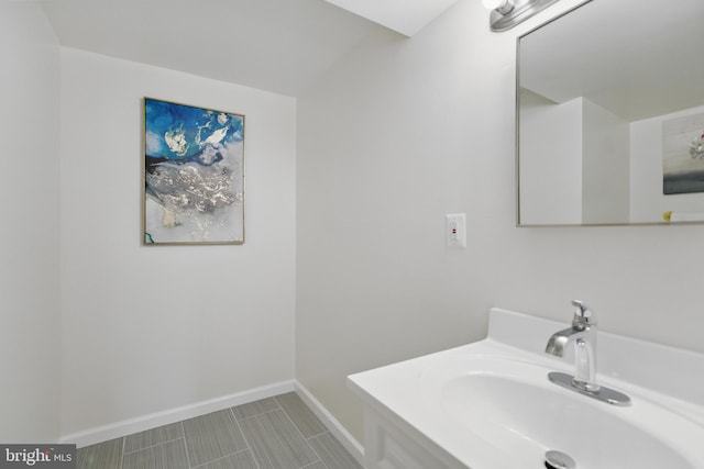 bathroom featuring baseboards and vanity