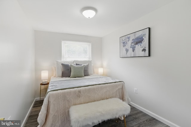bedroom with wood finished floors and baseboards