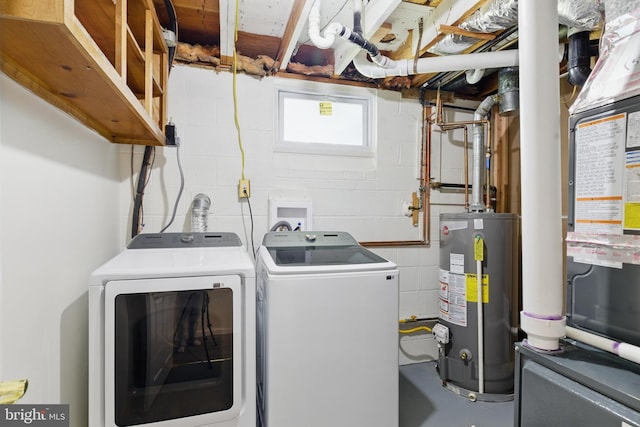 laundry area with water heater, separate washer and dryer, and concrete block wall