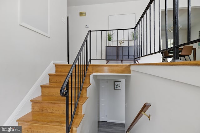 stairs featuring wood finished floors