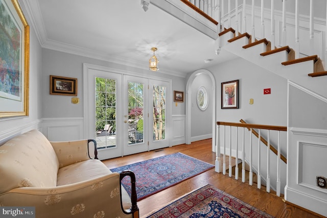 4064 Howell Rd, Malvern, PA 19355 - foyer entrance featuring crown molding, wainscoting, a decorative wall, wood finished floors, and stairway
