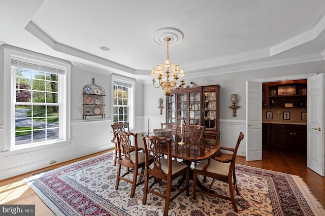 4064 Howell Rd, Malvern, PA 19355 - dining area with an inviting chandelier, a raised ceiling, a wainscoted wall, wood finished floors, and visible vents