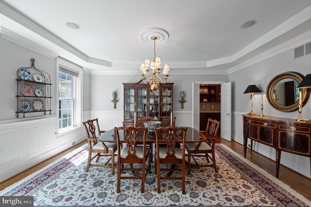 4064 Howell Rd, Malvern, PA 19355 - dining space with an inviting chandelier, a raised ceiling, crown molding, and wood finished floors