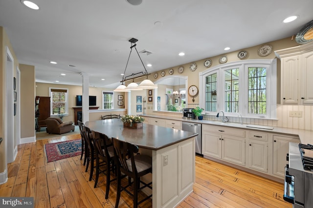 4064 Howell Rd, Malvern, PA 19355 - kitchen with a kitchen breakfast bar, decorative columns, visible vents, a sink, and stainless steel appliances