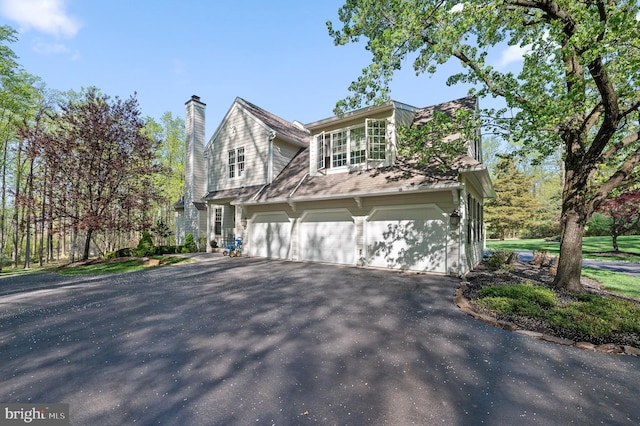 4064 Howell Rd, Malvern, PA 19355 - view of side of property with driveway, a chimney, and a garage