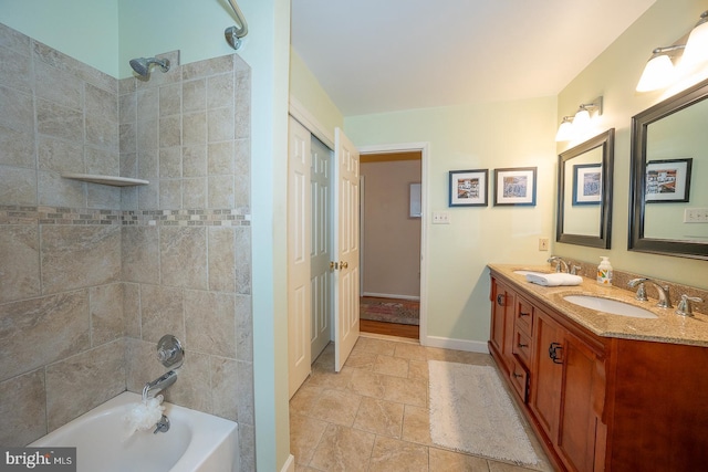 full bath featuring a sink, shower / bathing tub combination, double vanity, and baseboards