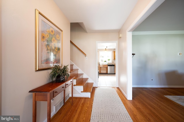 interior space with baseboards, wood finished floors, and stairs