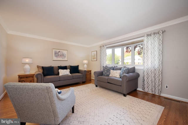 living area featuring visible vents, crown molding, and baseboards