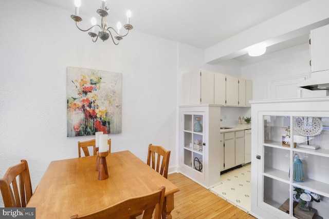dining space with an inviting chandelier and light wood-style flooring