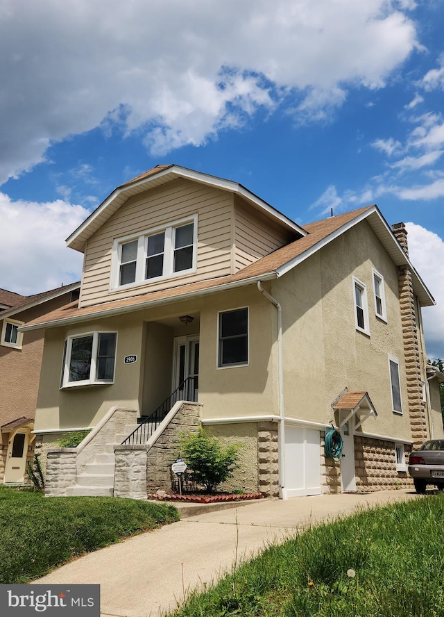 2906 Sylvan Ave, Baltimore, MD 21214 - view of front of home featuring stairs, stucco siding, a garage, and a chimney