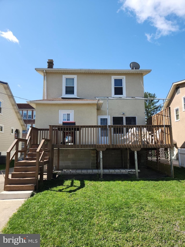 2906 Sylvan Ave, Baltimore, MD 21214 - back of property with a deck, stucco siding, stairs, and a lawn