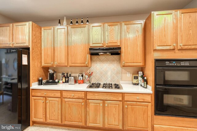 8733 Boulder Ridge Rd, Laurel, MD 20723 - kitchen featuring black appliances, under cabinet range hood, decorative backsplash, and light countertops
