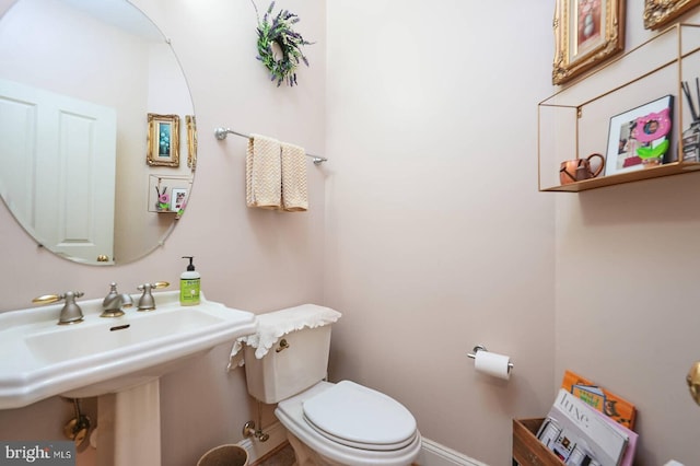 8733 Boulder Ridge Rd, Laurel, MD 20723 - half bathroom with toilet, a sink, and baseboards