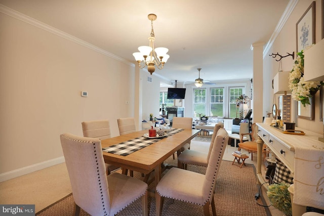 8733 Boulder Ridge Rd, Laurel, MD 20723 - dining space with a ceiling fan, crown molding, a chandelier, baseboards, and light colored carpet